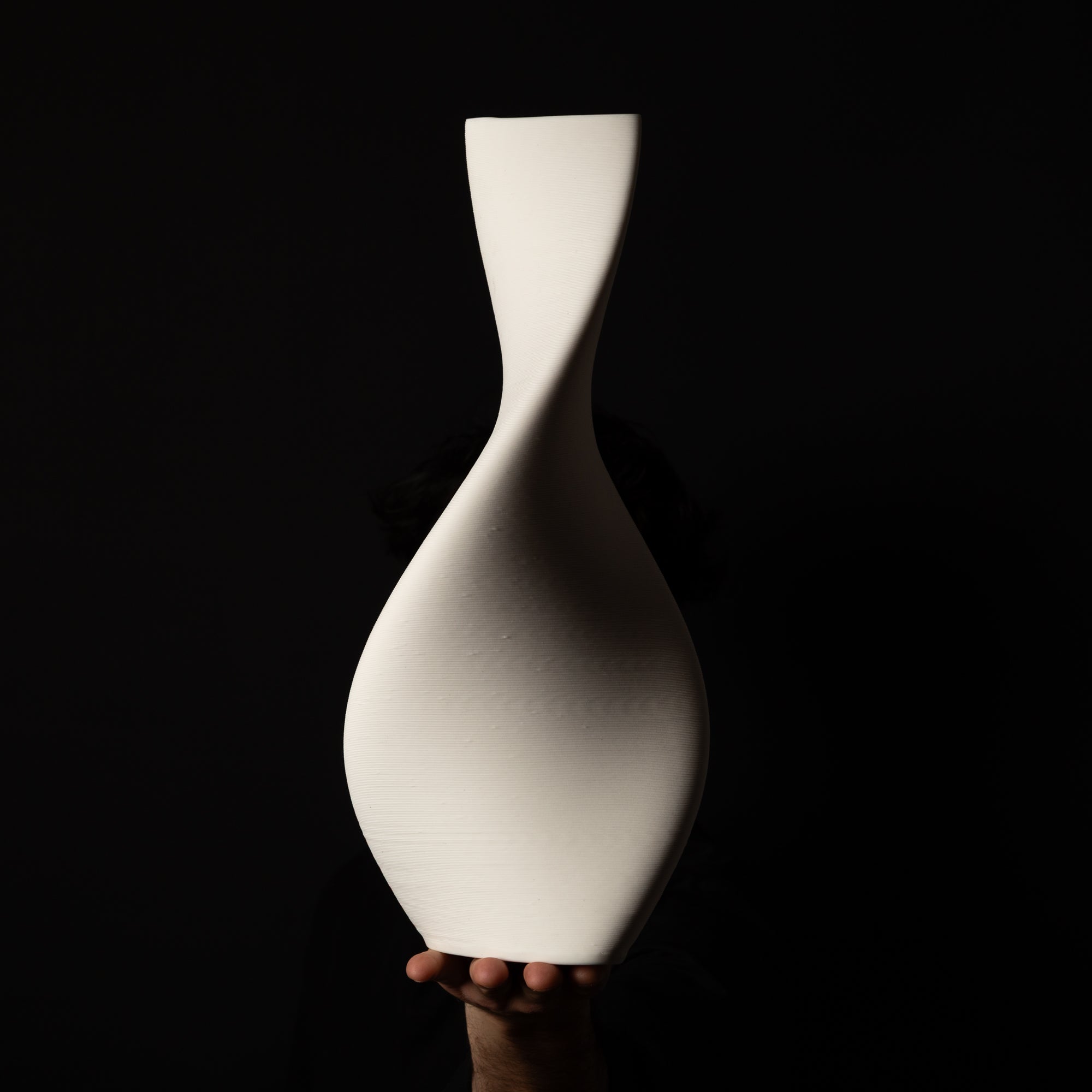 T-1001 Tornado Ceramic Sculpture – White Porcelain – artist holding side view – BinaryCeramics Athens