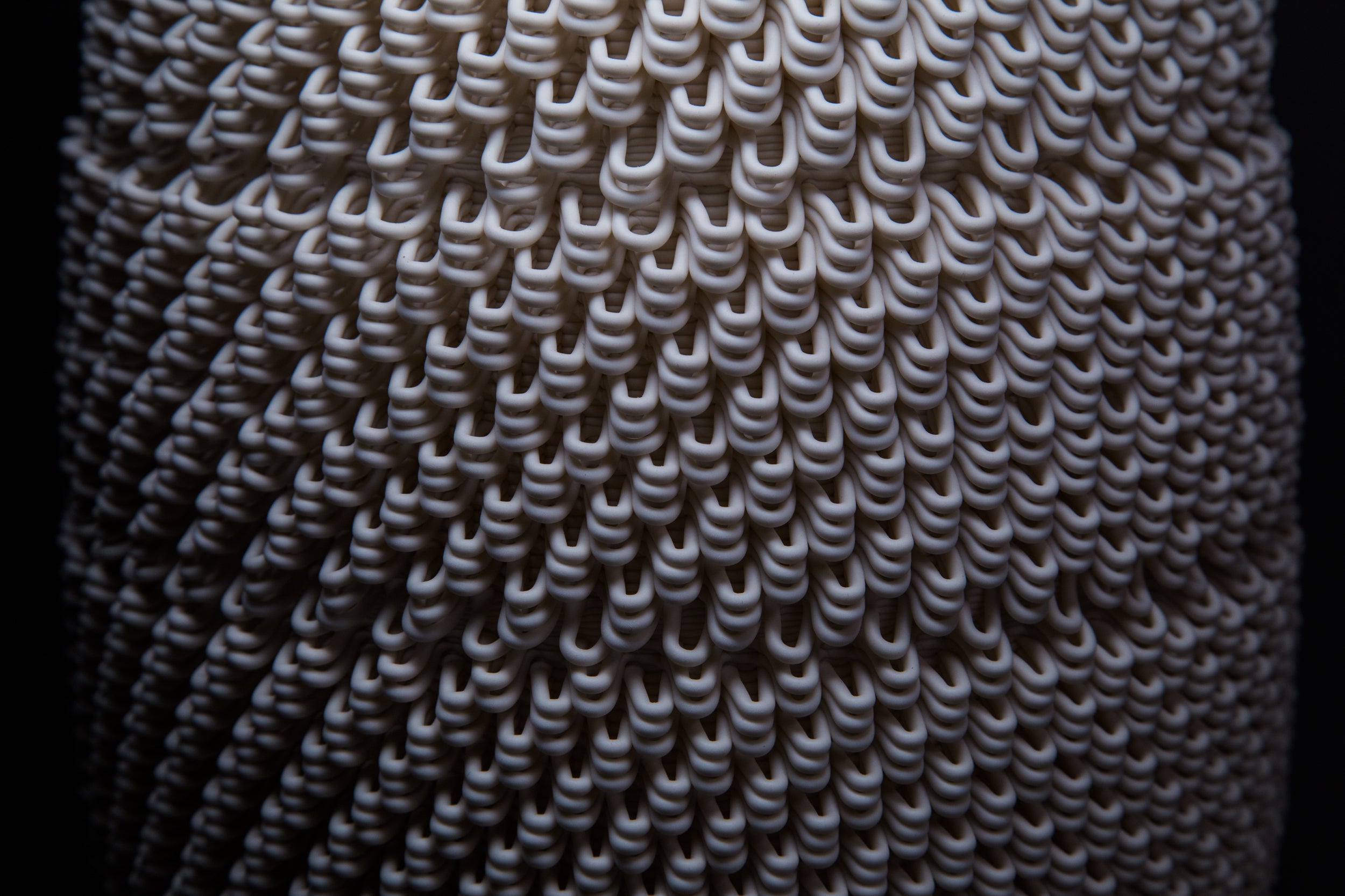 Close-up of 3D-printed ceramic vessel from the Dash series, showcasing layered geometry and digital texture
