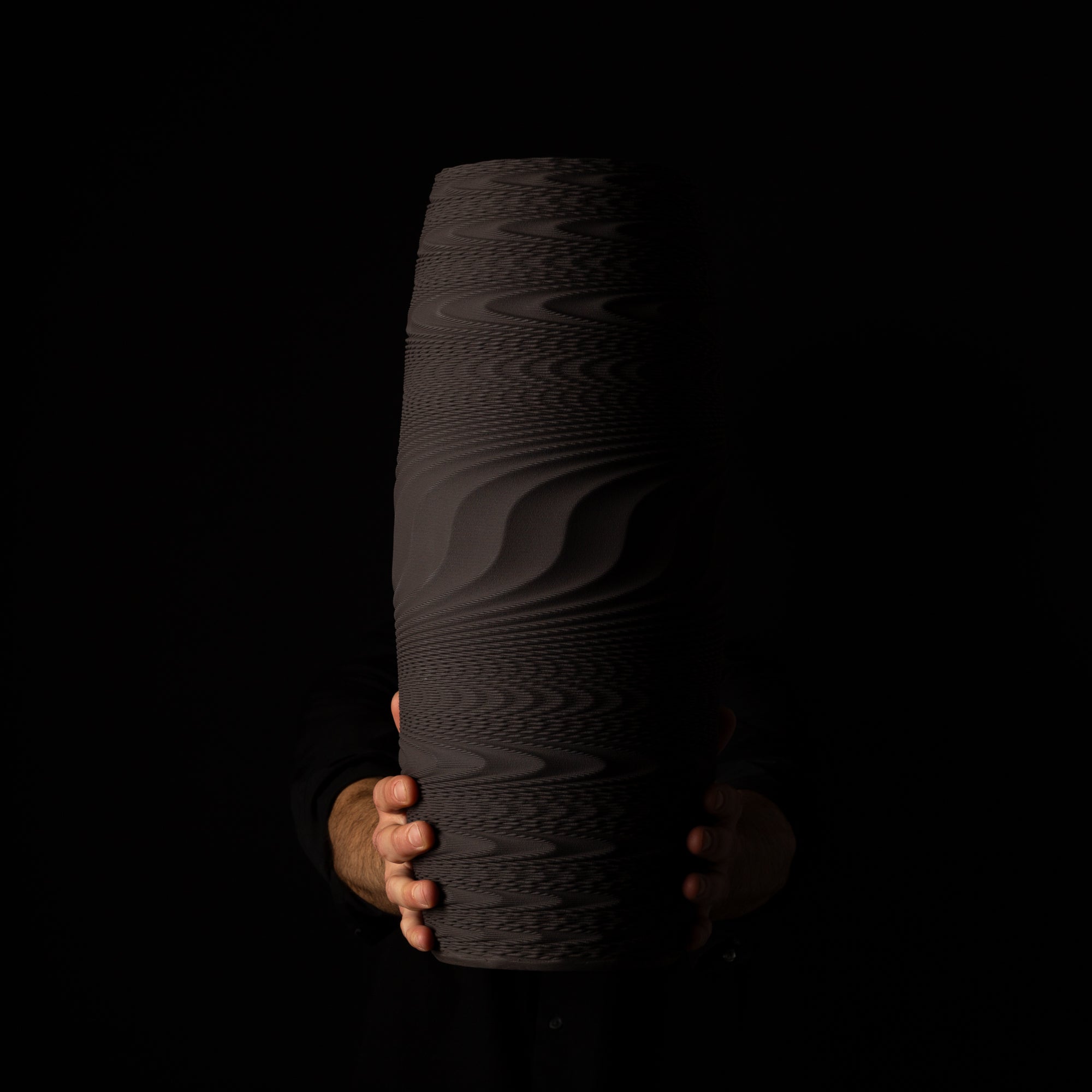 W-0100 Wave Layered Sculpture – Black Clay – artist holding – BinaryCeramics Athens