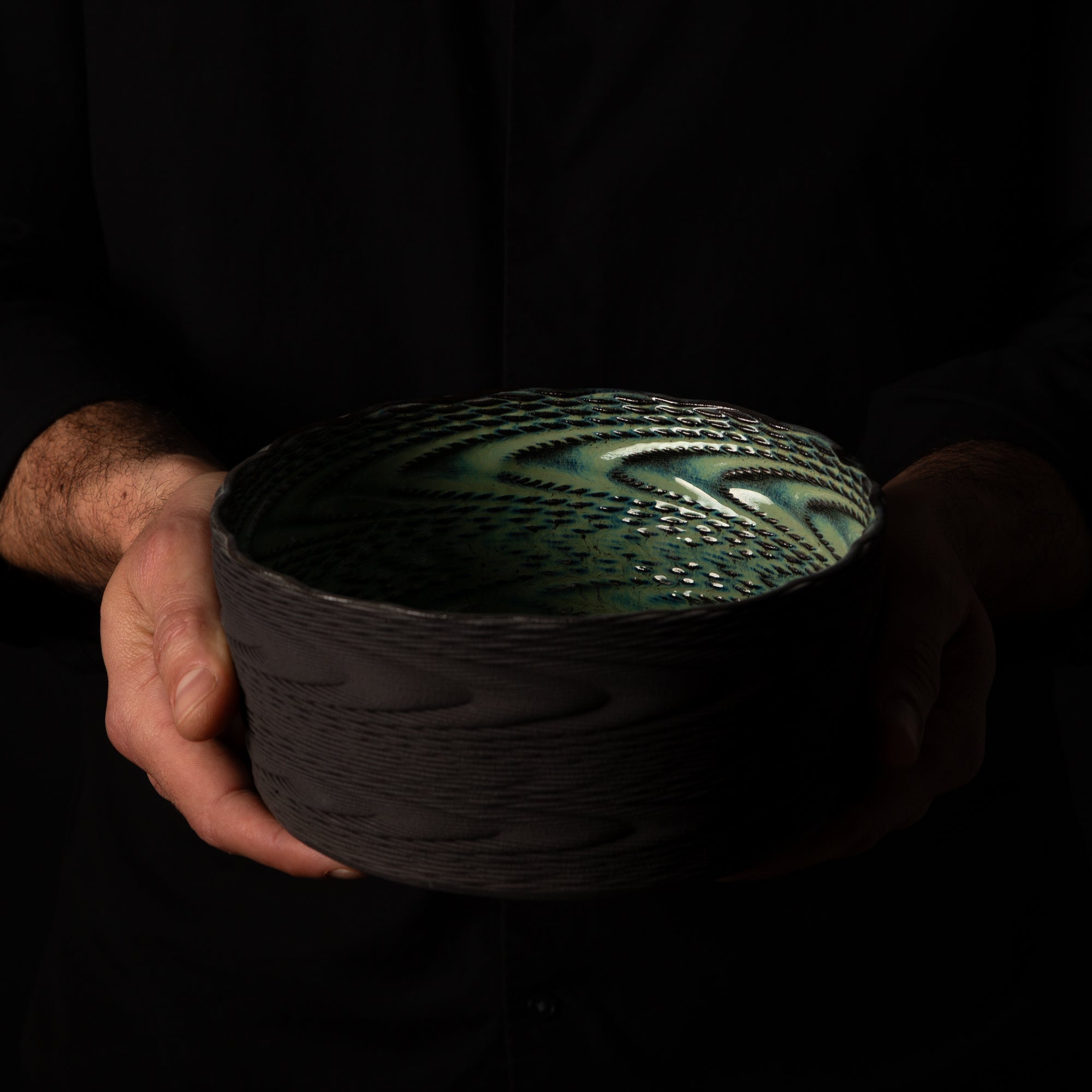 W-0011 Wave Layered Sculpture – Black Clay Green Glaze – artist holding – BinaryCeramics Athens