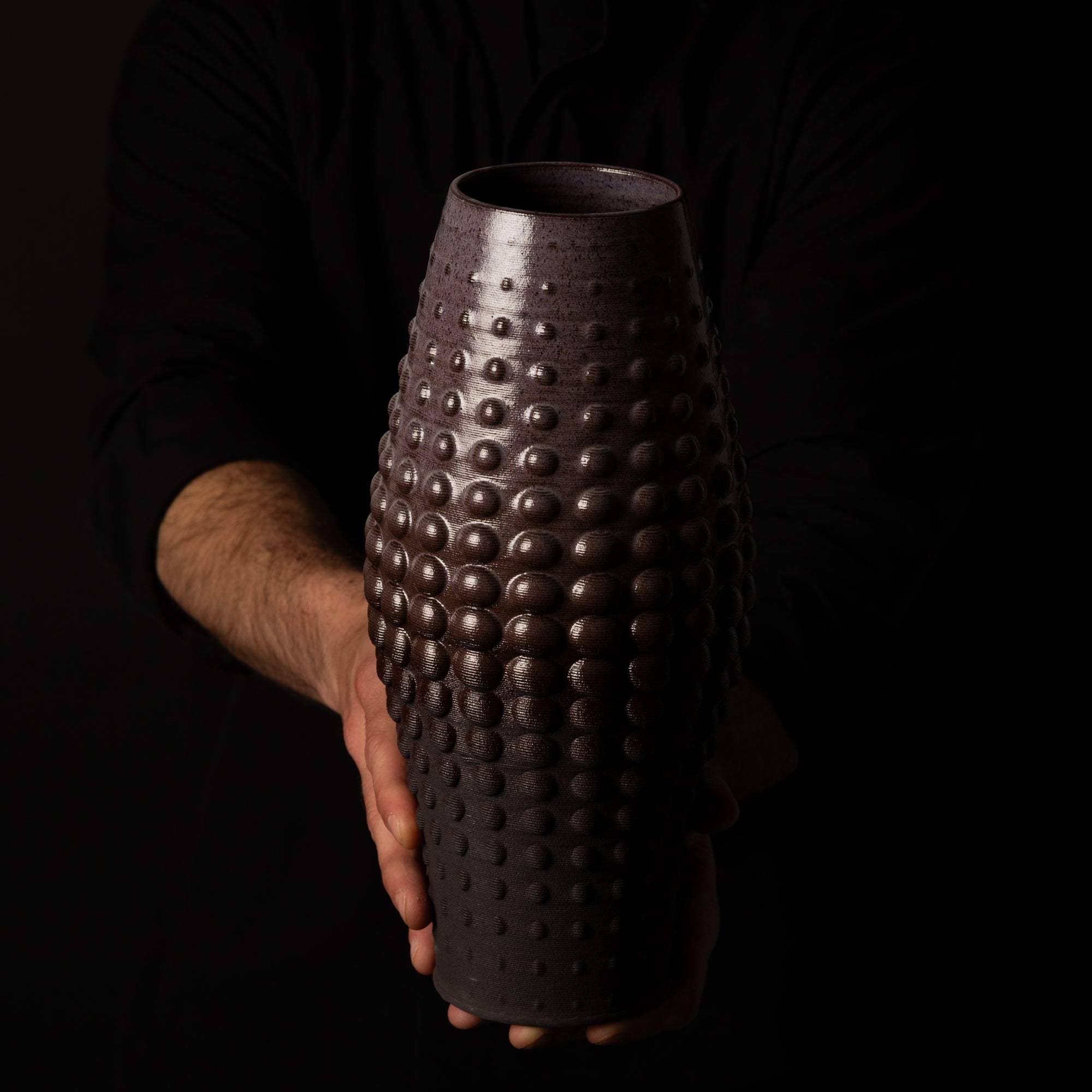 SW-0010 Sea Urchin Ceramic Sculpture – Black Clay Purple Glaze – artist holding – BinaryCeramics Athens