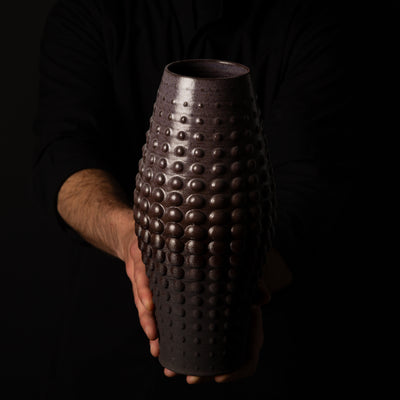 SW-0010 Sea Urchin Ceramic Sculpture – Black Clay Purple Glaze – artist holding – BinaryCeramics Athens