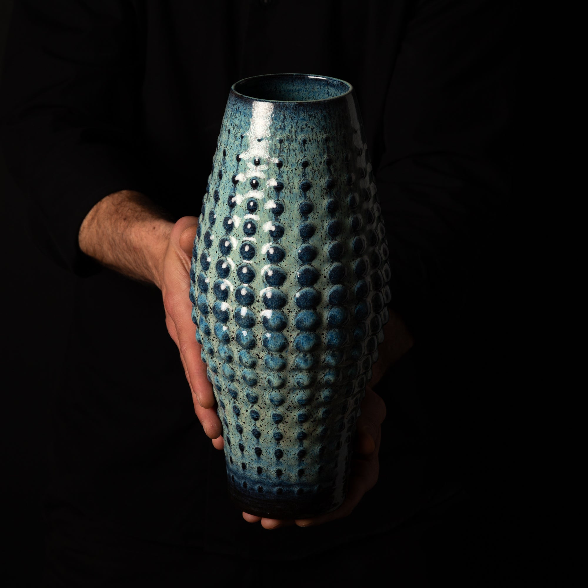 SW-0010 Sea Urchin Ceramic Sculpture – Black Clay Blue Glaze – artist holding – BinaryCeramics Athens