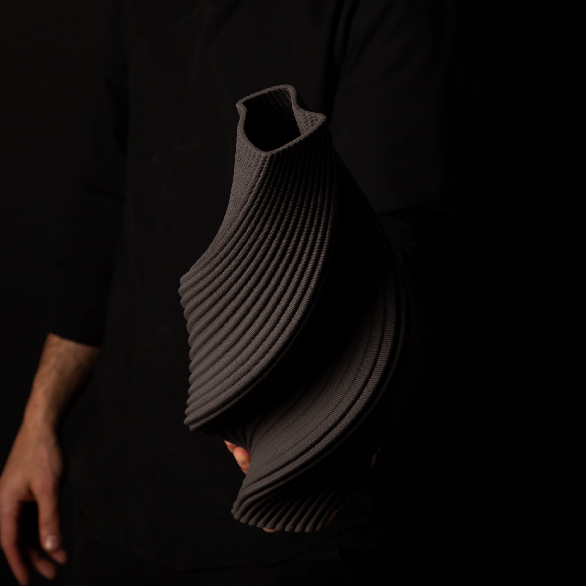 T-1000 Tornado Ceramic Form – Black Clay – artist holding side view – BinaryCeramics Athens